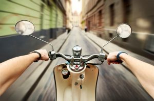 Man driving on scooter